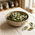Illustrative image of dried curry leaves in a ceramic bowl