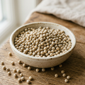 Illustrative image of whole white peppercorns in a ceramic bowl