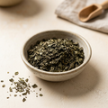 Illustrative image of dried basil leaves in a ceramic bowl