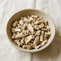 Illustrative image of dried orris root pieces in a ceramic bowl