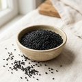Illustrative image of whole nigella seeds in a ceramic bowl