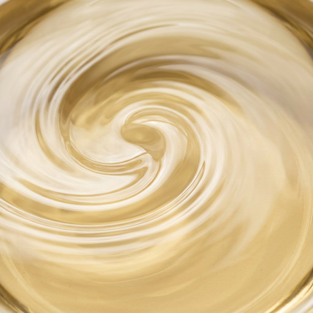 Close-up of pale golden castor oil filling a square frame