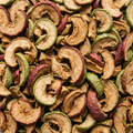 Dried red and green apple slices filling a square frame