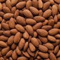 Close-up of whole activated almonds filling the square frame
