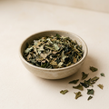 Illustrative image of dried dandelion leaf tea in a ceramic bowl
